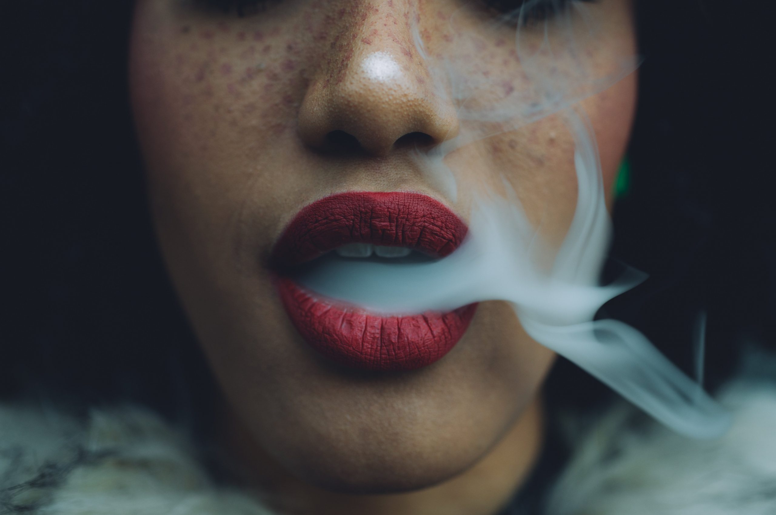 woman exhaling after smoking a joint