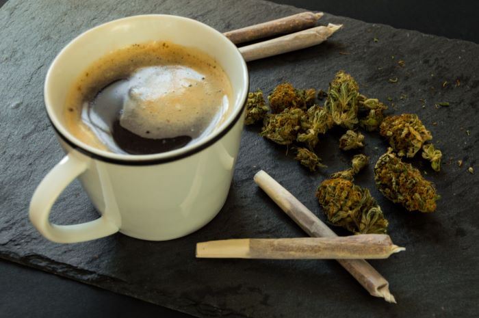 cup of coffee with marijuana and joints