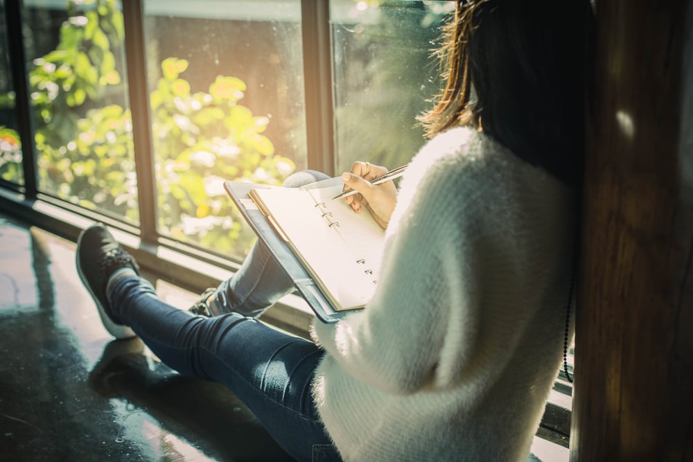 woman writing in a journal