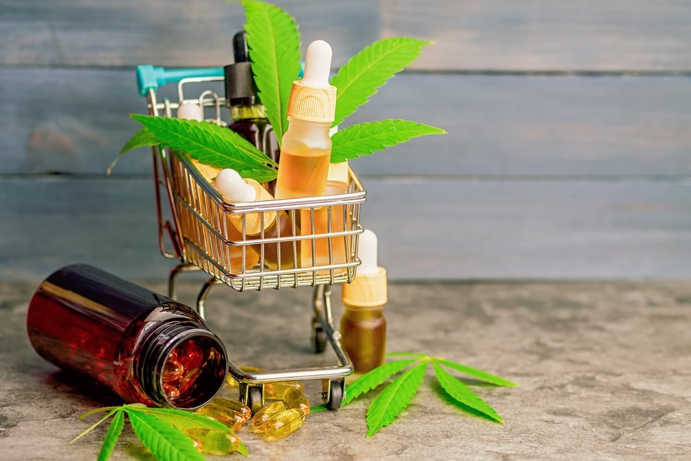 marijuana buds and products in a minature shopping cart