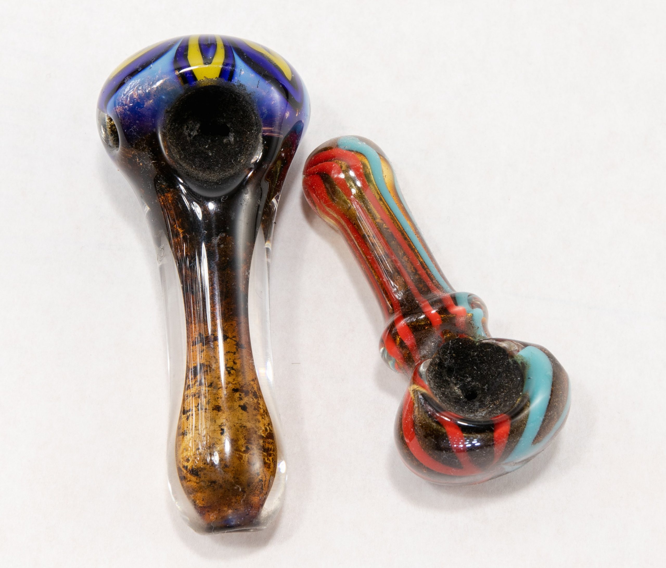 two dirty resinated glass pipes
