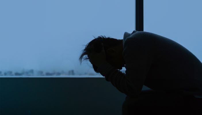 silhouette of man on bed ptsd