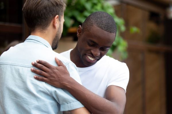 two friends hugging in support of each other