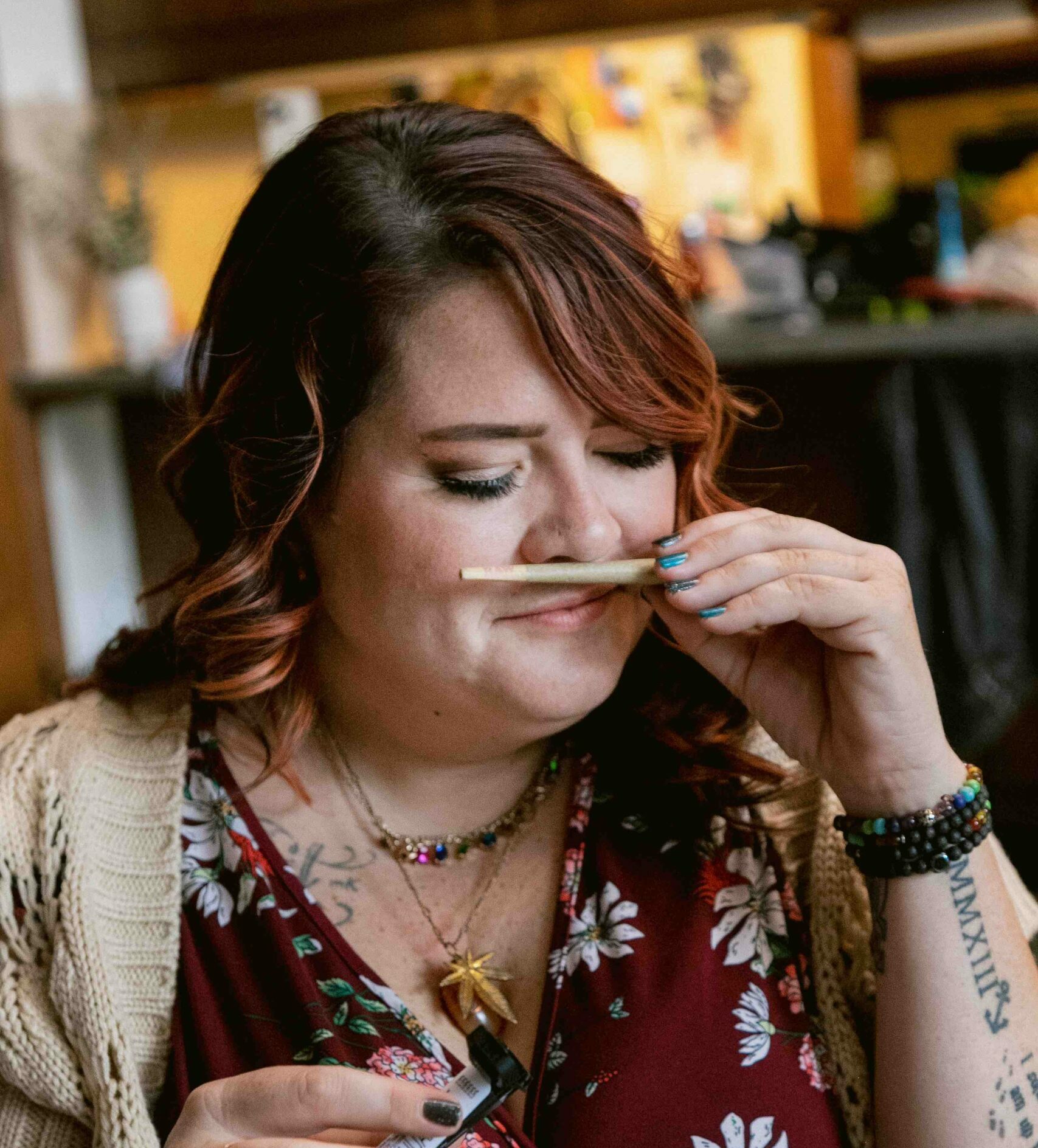 woman smelling a pre rolled marijuana joint