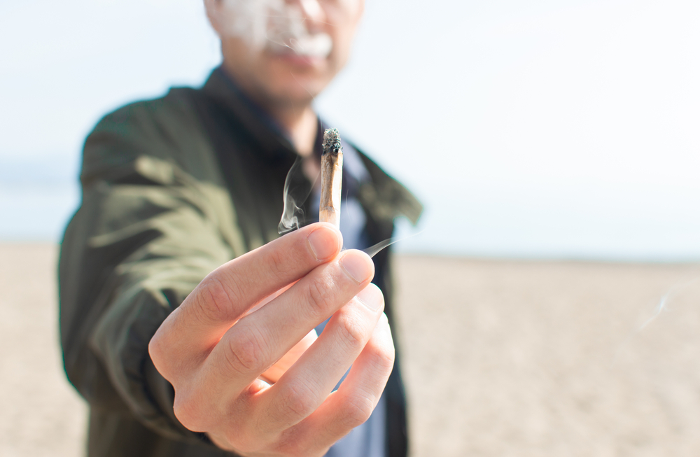 man holding marijuana joint