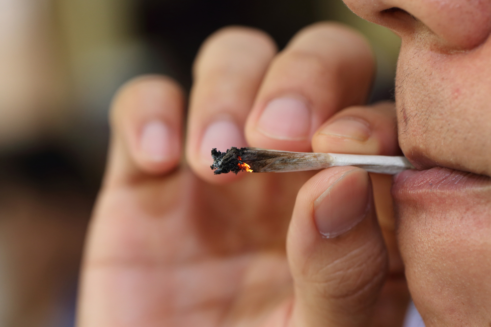 person smoking marijuana roach joint